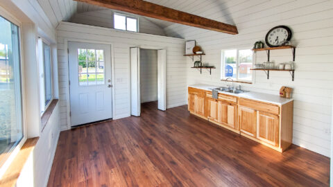 Spacious interior of the Black Bear Modular featuring natural wood cabinetry, a functional kitchen space, and an open layout.